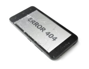A mobile phone with a cracked screen shows a 404 screen.