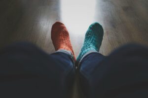 A person wearing a pair of mismatched socks, illustrating the obviousness of mismatched branding assets.