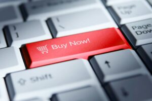 A keyboard features a red "Buy Now" button illustrating e-commerce.