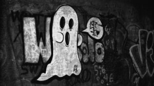 Black and white graffiti of a cartoon ghost on a weathered urban wall, representing the ghost listings and fake businesses that haunt Google Maps local search results.